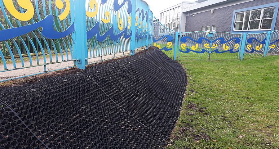 Rubber Grass Mats Covering A Soil Bank - Featured Image