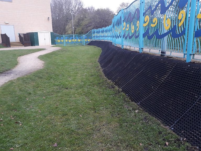 Rubber Grass Mats Covering A Soil Bank - Rubber Grass Mats Installed