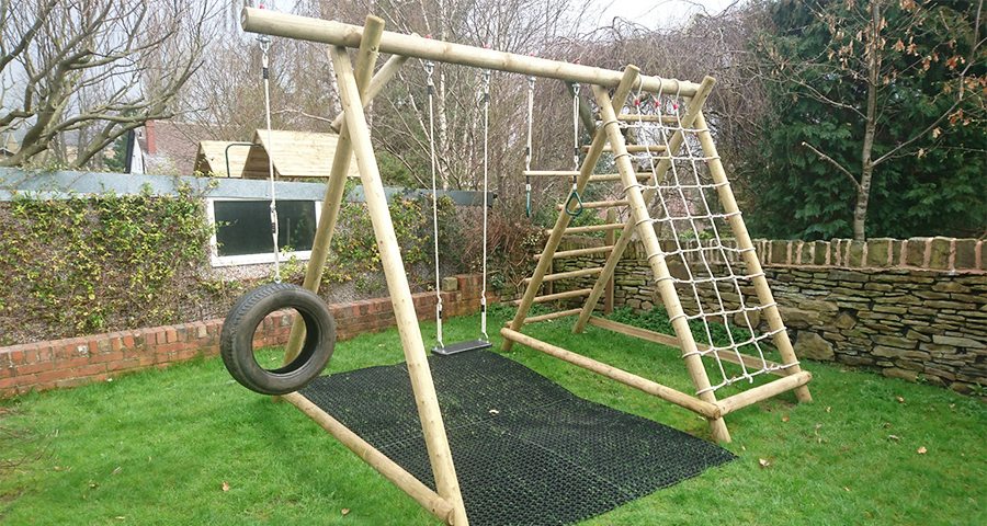Rubber Grass Mats Installed Under A Caledonia Play Swing Set - Featured Image