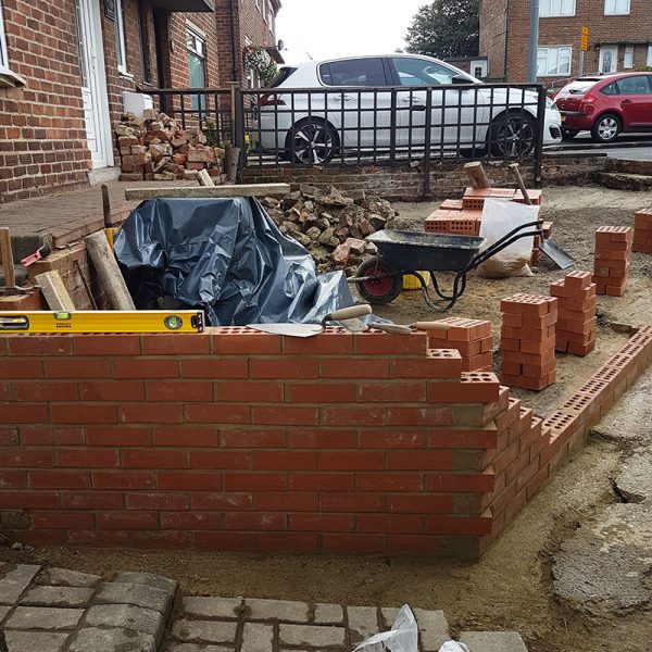 Perimeter walls built up to create gravel driveway